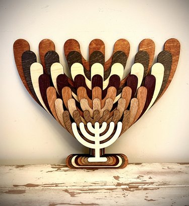 Wooden stacked 3D menorah on table