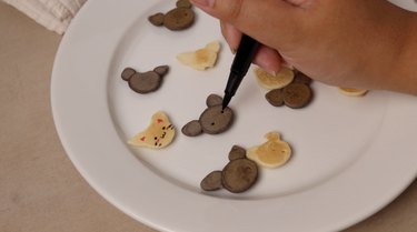 Drawing cat faces with edible markers