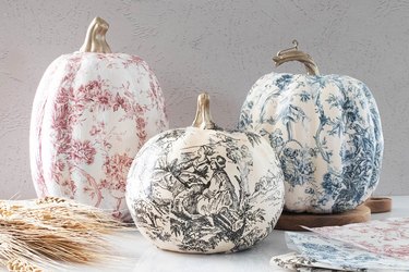 Pumpkins covered with black, pink and blue tissue paper