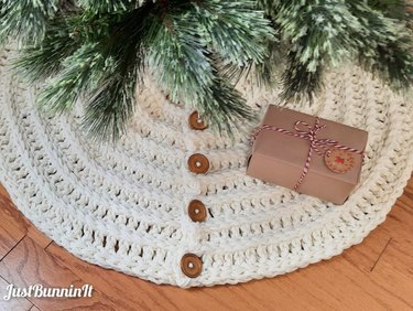 White crochet Christmas tree skirt with brown buttons