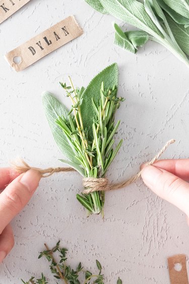 Wrapping jute cord around fresh herbs