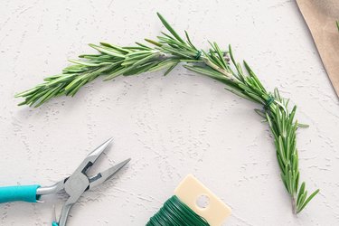 Wrapping rosemary sprigs with floral wire