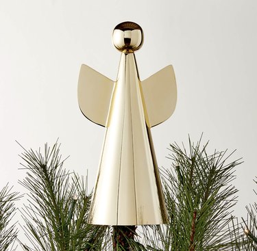 Modern brass angel Christmas tree topper with a round head and cone-shaped body.