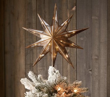 Pre-lit star on top of tree with a rosegold finish and LED lights powered by batteries.