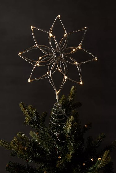 Pre-lit flower tree topper with gold glitter in the shape of a poinsettia.