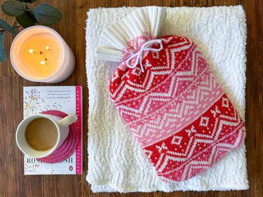 Hot water bottle cover made from a red and white upcycled sweater