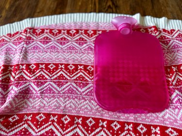 Place hot water bottle on sweater and measure