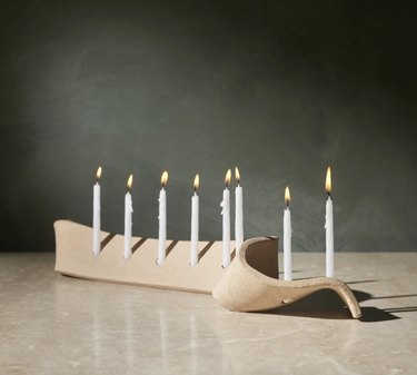 Beige stoneware menorah with white candles
