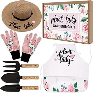 The Percozzi plant lady gardening gift set includes a floral patterned apron, gloves, straw hat and three gardening tools.