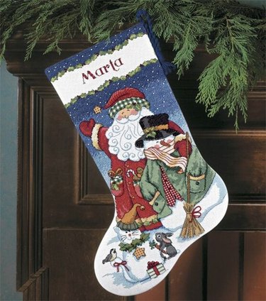 A Christmas stocking featuring Santa with his arm around a snowman.