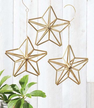 Three geometric star ornaments hanging from the ceiling