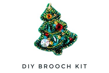 A sparkling Christmas tree-shaped felt brooch with colorful glass beads and sequins.