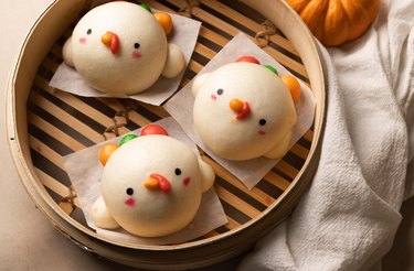 Cute white turkey buns in a steamer basket.