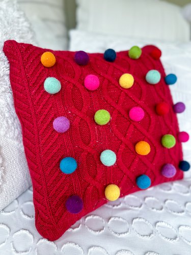 finished cable-knit sweater pompom pillow