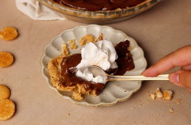 Slice of chocolate pudding pie with whipped cream on top.