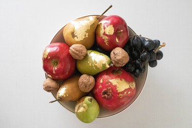 Various fruit with gold leaf in a bowl