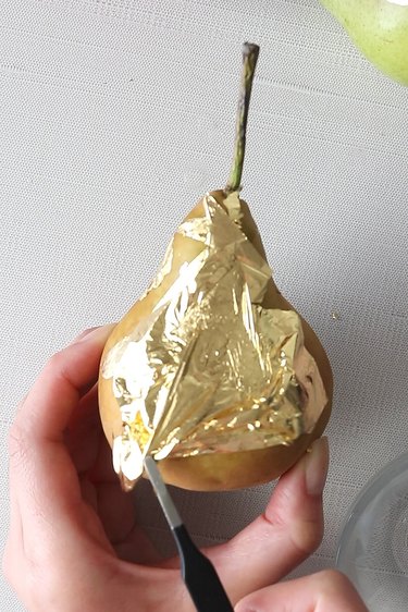 Adding gold leaf to pear