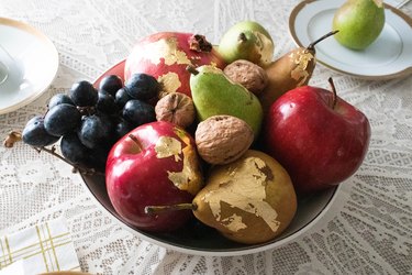 Fruit with gold leaf in a bowl