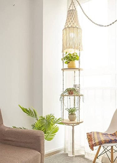 This stylish macrame plant hanger has three floating shelves, a lampshade and light socket assembly with all parts and is 77 inches long.