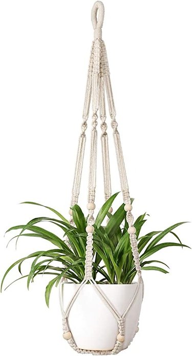 The Mkona macrame plant hanger is made of 100 percent cotton, has stylish beads, is 35 inches long and holds 9-inch pots.
