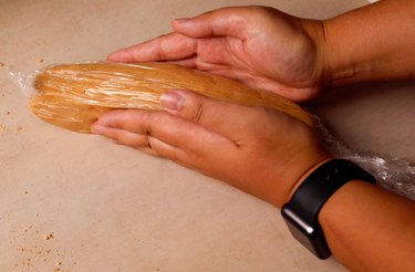 Shaping graham cracker shortbread into a log