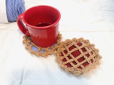 Finished blueberry and cherry pie coasters with mug on top