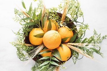 Add wheat stems to the orange centerpiece