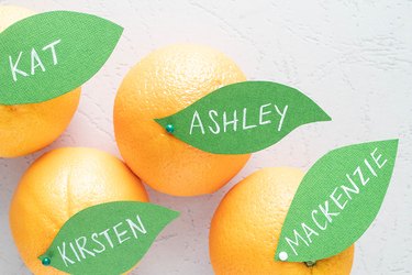 Pin paper tags to oranges