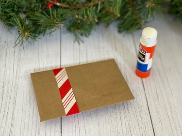 attach paper strip to envelope with a glue stick