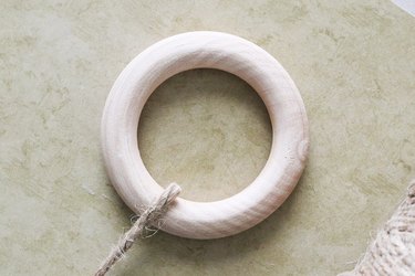 Wrap twine around wooden ring