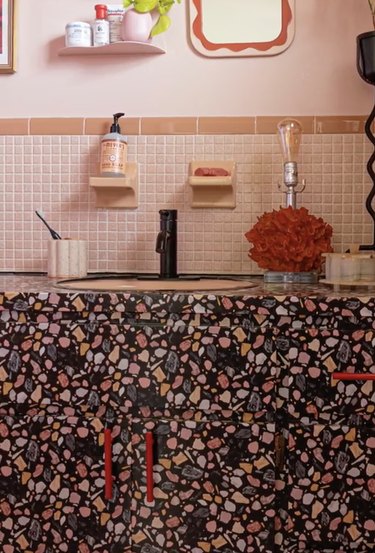 Pink tile bathroom with speckled contact paper countertop