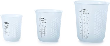 Set of three OXO silicone measuring cups, shown on a white ground