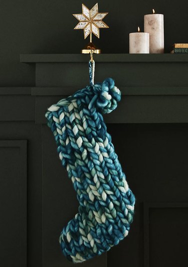 Blue and white knit stocking hanging on mantel