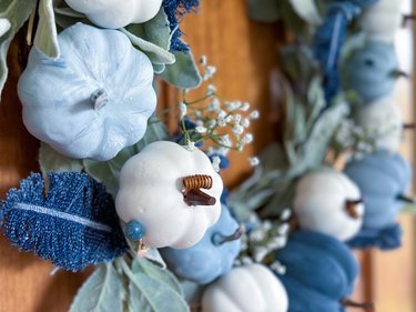 Finished denim feather and blue pumpkin wreath