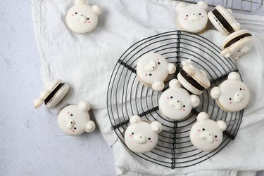 Cheesecake-filled white macarons designed to look like polar bear faces.