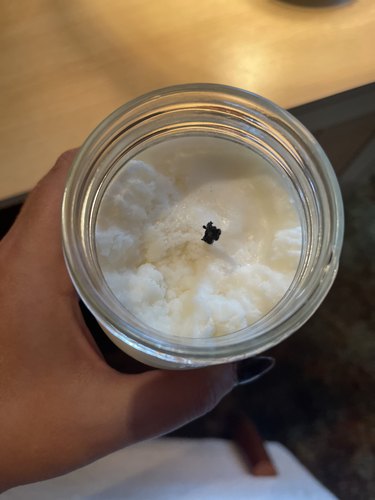Uneven wax texture of a soy candle in a Mason jar.