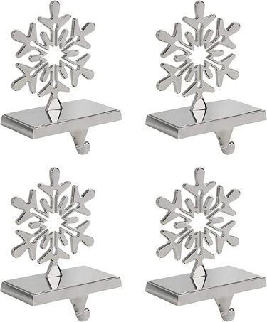 Four silver snowflake stocking holders