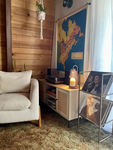 Vertical shot of a cabin interior with a candle warmer lamp sitting on a table.