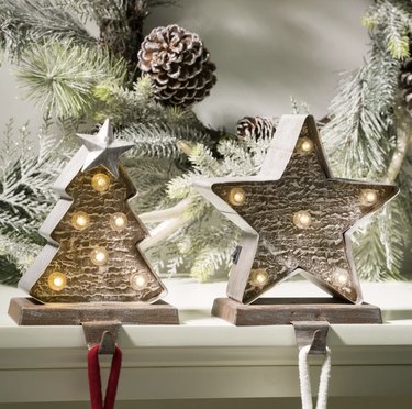 A star and a Christmas tree light-up Christmas stocking holders