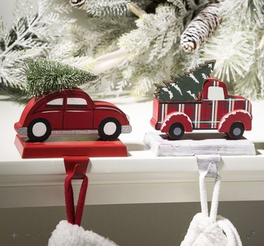 Car and truck stocking holders holding Christmas trees