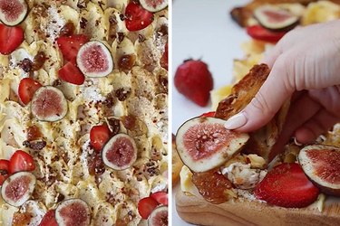 A wooden cutting board topped with butter, figs, strawberries, fig jam and salt