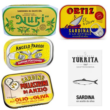 A selection of premium sardines from Spain, Portugal and Italy, arranged in their retail packaging on a white ground