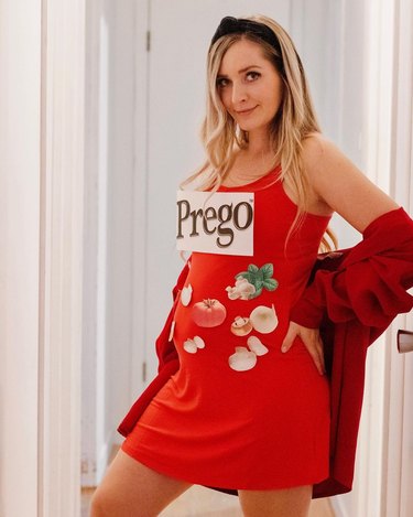 Pregnant woman in a red dress covered with printed photos of vegetables and a logo reading "Prego"