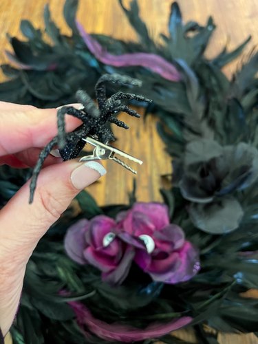 clipping spiders onto the feather wreath