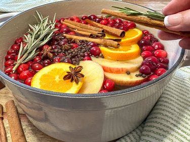 adding aromatic ingredients to a simmer pot recipe