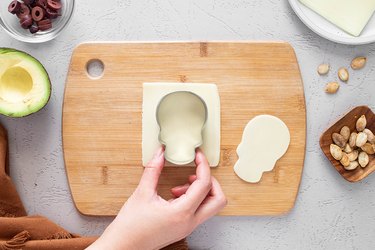 Cutting cheese with skull cookie cutter
