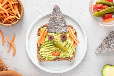 Witch avocado toast with tortilla chip hat and carrot hair