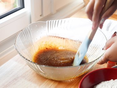 mixing butter and sugars in a glass mixing bowl