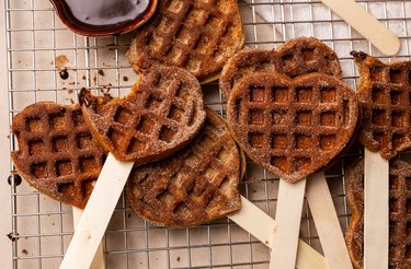 Heart-shaped mochi waffles on Popsicle sticks.