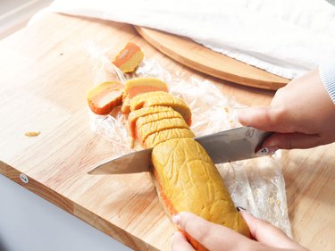 Slicing log of candy corn cookie dough